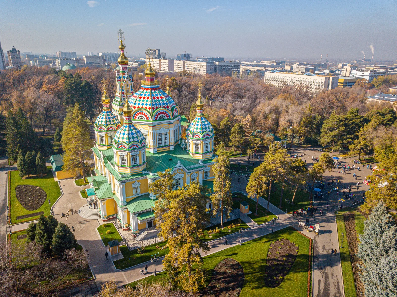 Ascension Cathedral's colorful domes surrounded by trees and mountains