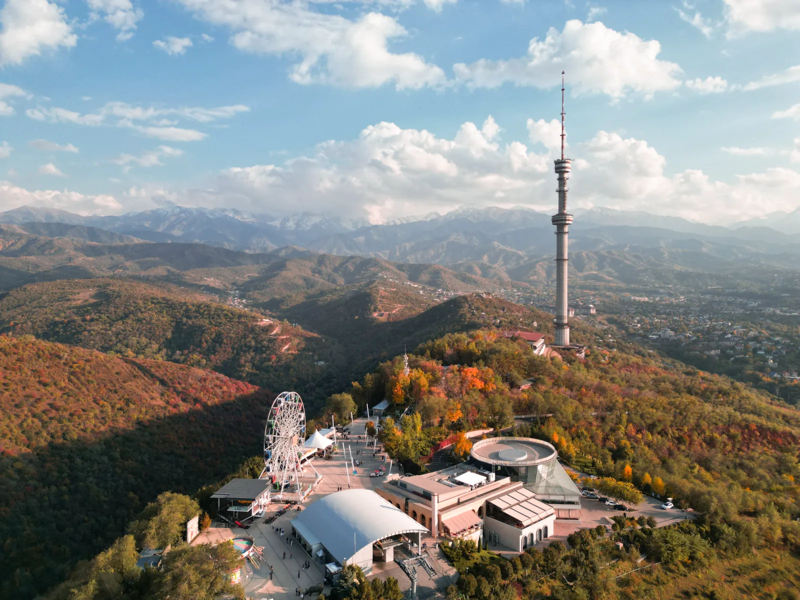 Aerial view of Kok Tobe's TV tower and ferris wheel above the autumn city
